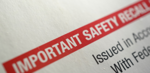 Close-up of a document with a red banner labeled IMPORTANT SAFETY RECALL in bold text