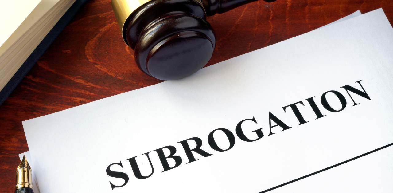 Document titled Subrogation on a desk next to a judge's gavel, suggesting a legal or insurance context