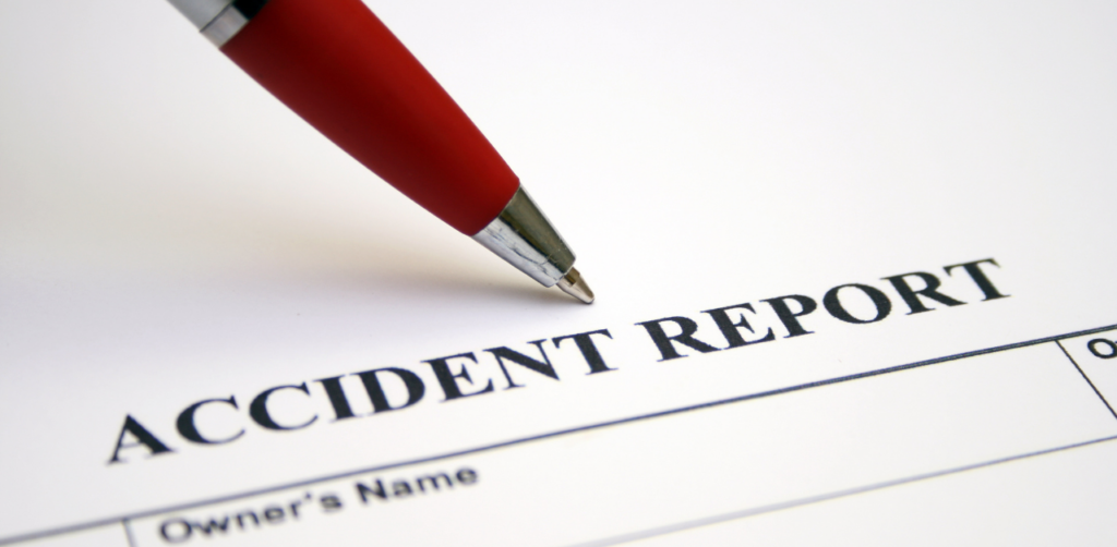 Pen resting on a document labeled Accident Report
