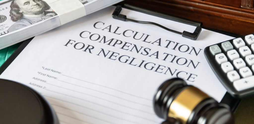Legal document titled Calculation Compensation for Negligence on a clipboard, surrounded by a gavel, cash, and a calculator—key elements in car accident claims in Las Vegas