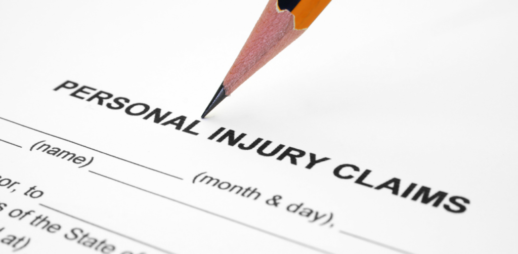 Sharpened pencil points to the words Personal Injury Claims on a blank legal form