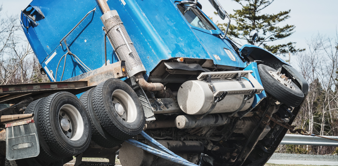 Blue semi-truck overturned after highway accident