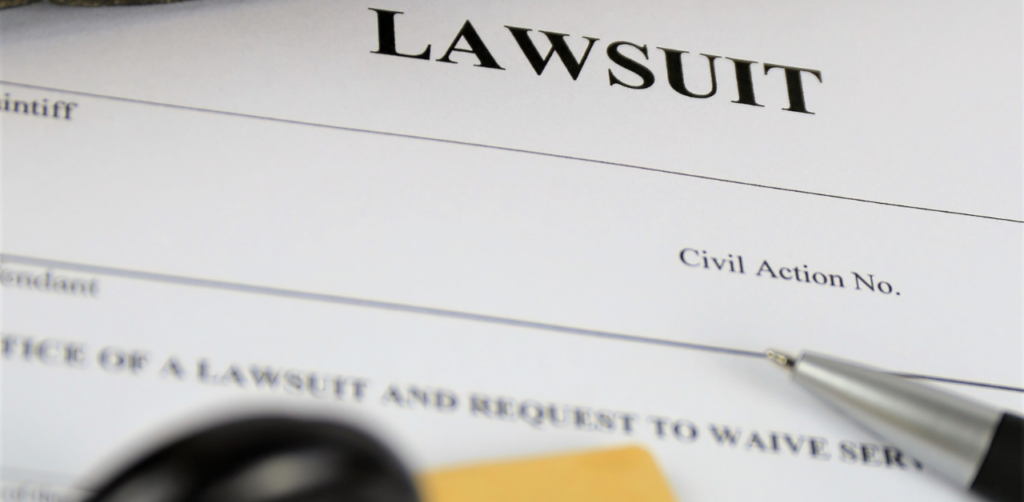 Close-up of a legal document titled “Lawsuit” with a pen and gavel