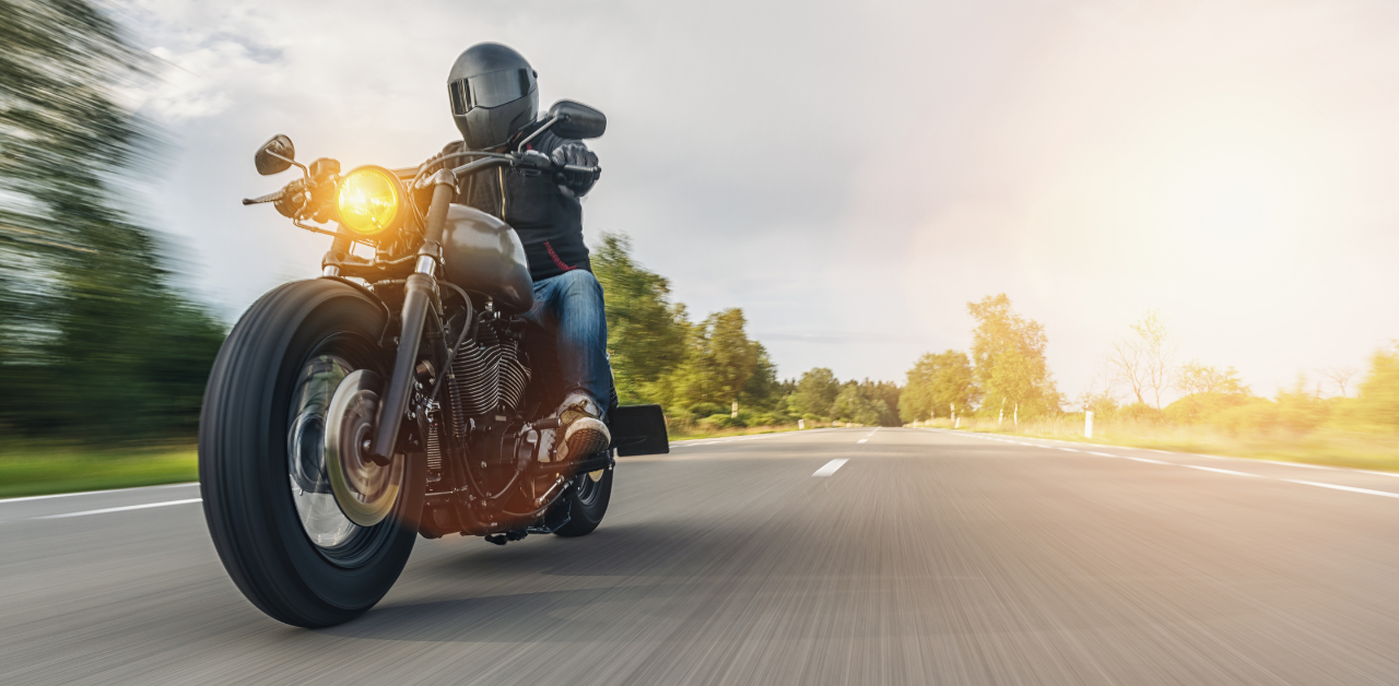 Motorcyclist speeds down highway in full gear, showcasing freedom and skill gained from a motorcycle license