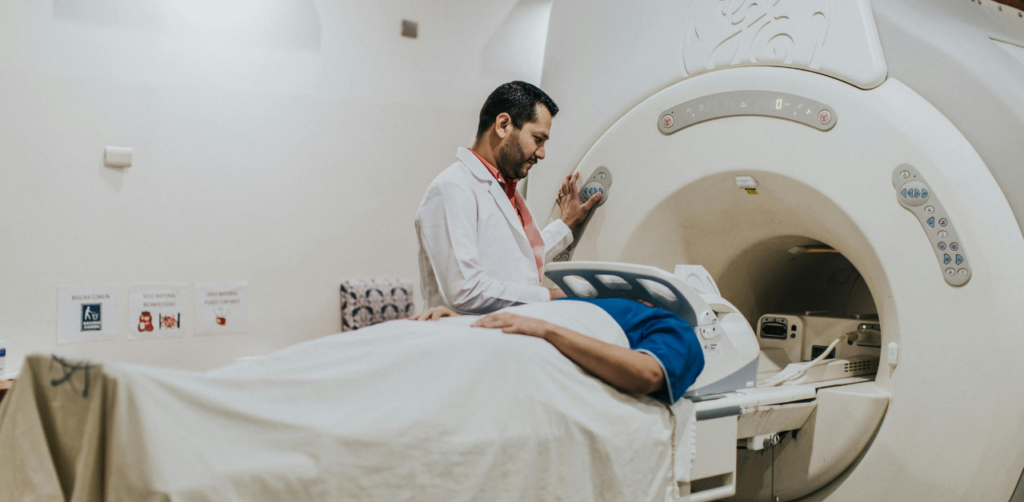 Doctor prepares a patient for an MRI scan inside a hospital's imaging room