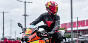 Motorcyclist in full racing gear riding a Red Bull-branded KTM bike