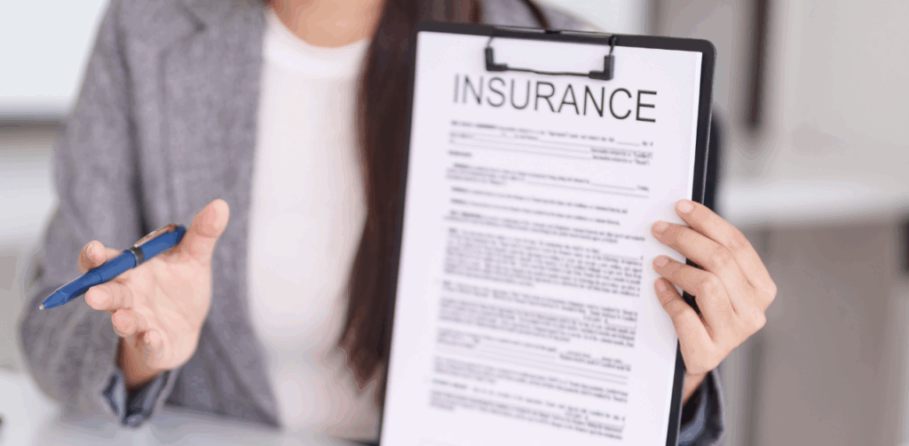 Woman presents insurance form, explaining accident compensation coverage to a client