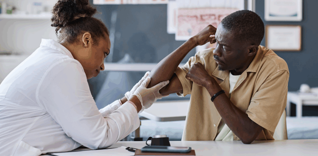 Doctor examines a man's injured arm during a medical consultation