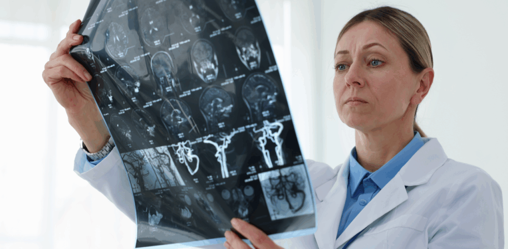 Female doctor closely examines brain scan images in a clinical setting