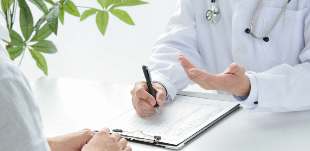 Doctor consulting a patient and taking notes during a medical appointment