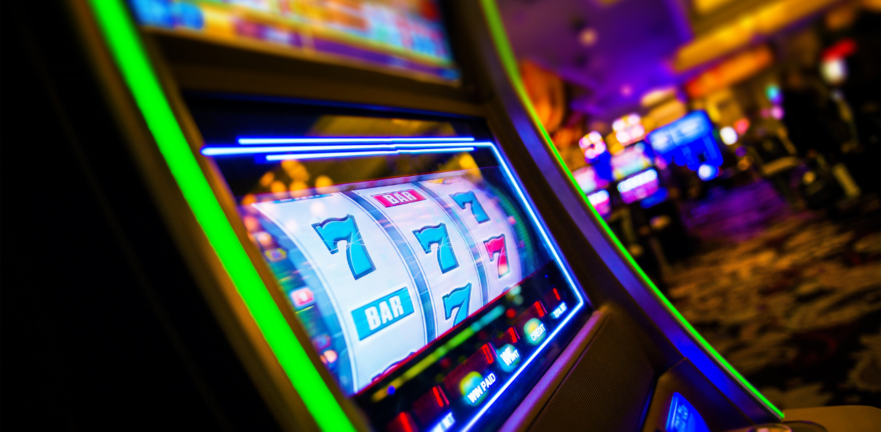 Slot machine with triple sevens in a vibrant casino setting, representing a winning jackpot
