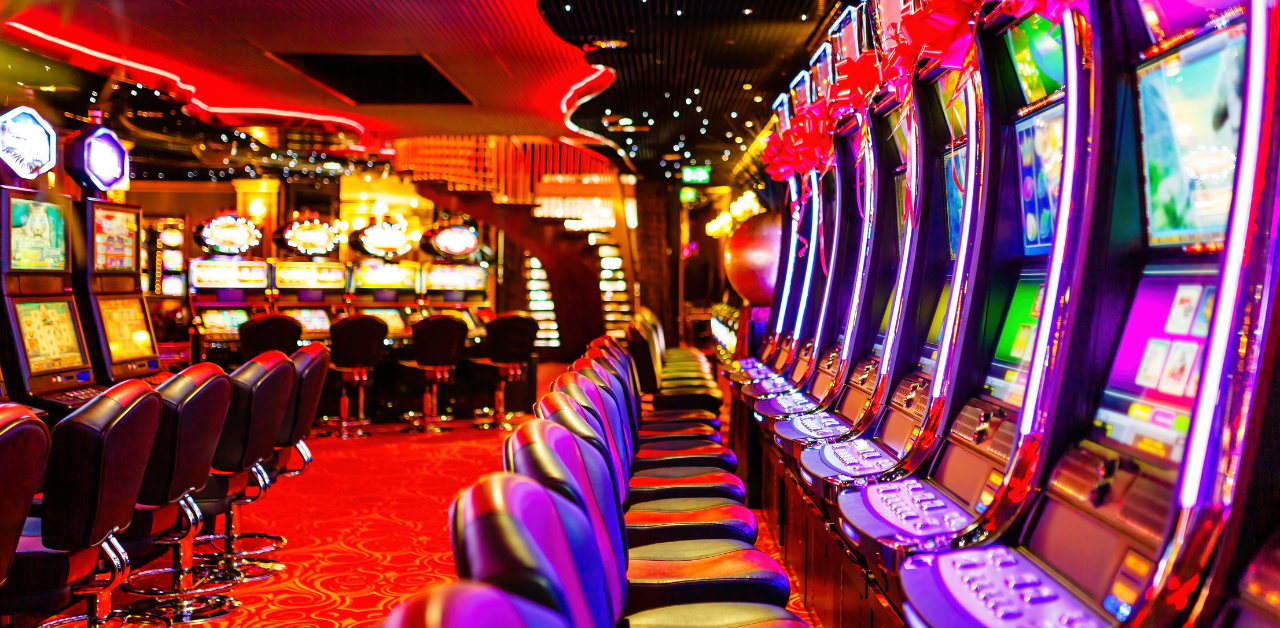 Bright casino floor with slot machines and neon lights, representing gambling, gaming entertainment, and risk