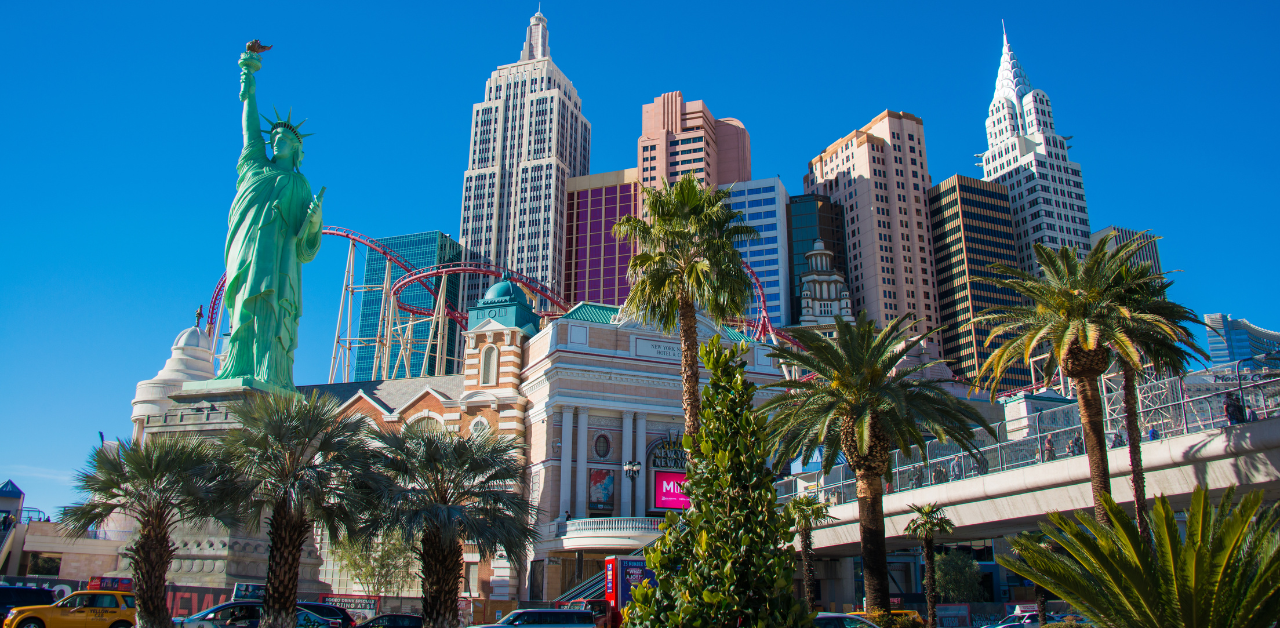 Las Vegas skyline with replica Statue of Liberty and roller coaster, capturing vibrant city architecture and tourism