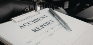 Close-up of an accident report form on a clipboard with a pen, suggesting insurance or incident documentation