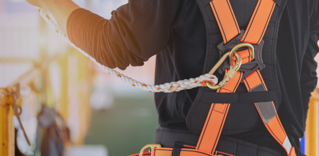 Close-up of a worker wearing a fall protection harness attached to a safety lifeline