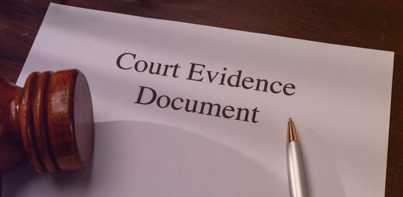 Court evidence document with a gavel and pen on a wooden desk