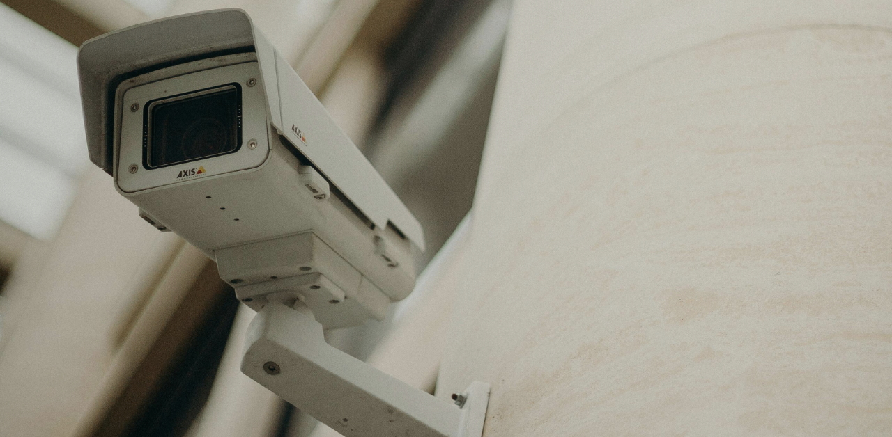 Security camera mounted on a wall monitors an indoor area