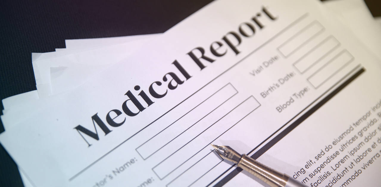 Close-up of a medical report form with blank fields and a fountain pen resting on the page