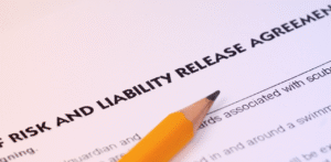 Close-up of a pencil resting on a document titled Risk and Liability Release Agreement