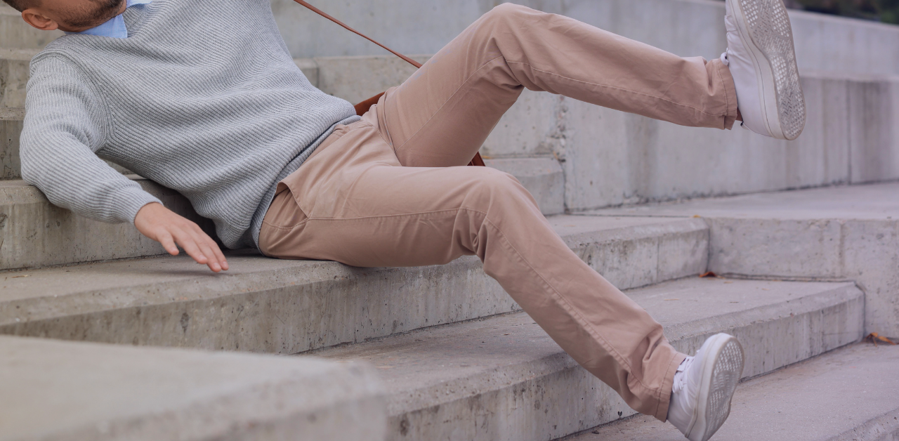 Person slips and falls on concrete steps, landing on the stairs